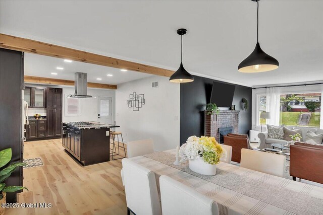 55 Fairview Ave, Hudson, NY 12534 - dining area featuring light wood finished floors, a brick fireplace, recessed lighting, and beamed ceiling
