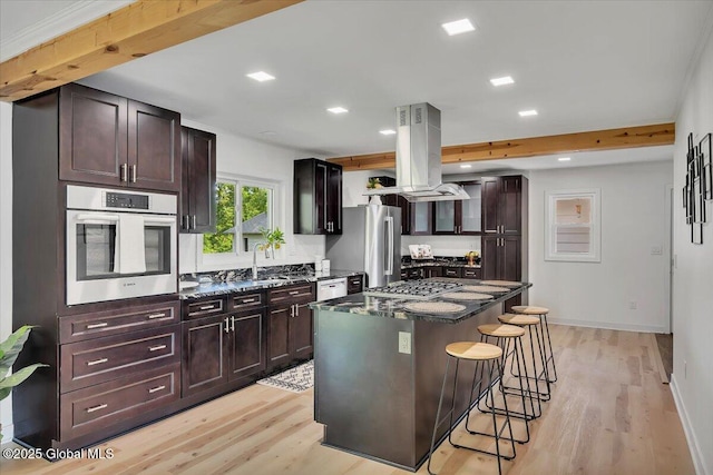 55 Fairview Ave, Hudson, NY 12534 - kitchen with stainless steel appliances, island exhaust hood, a kitchen breakfast bar, light wood-style floors, and recessed lighting