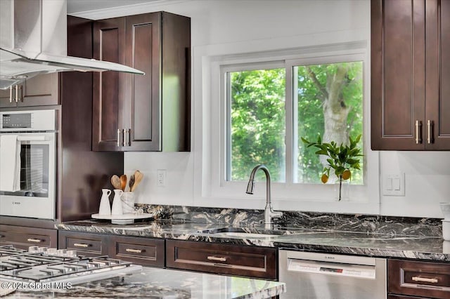 55 Fairview Ave, Hudson, NY 12534 - kitchen with stainless steel appliances, wall chimney range hood, dark brown cabinetry, dark stone counters, and a sink