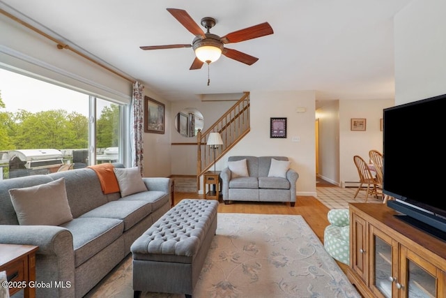 440 Posson Hill Rd, Middleburgh, NY 12122 - living room with ceiling fan, stairway, wood finished floors, baseboards, and a baseboard radiator