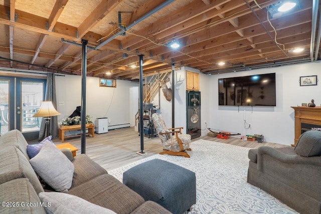 440 Posson Hill Rd, Middleburgh, NY 12122 - living area with a baseboard heating unit, plenty of natural light, and light wood-style floors