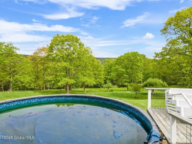 440 Posson Hill Rd, Middleburgh, NY 12122 - swimming pool with a lawn, a view of trees, and a wooden deck