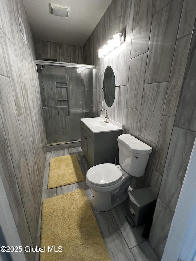 94 Willow Ave, Schenectady, NY 12304 - full bath featuring tile walls, toilet, vanity, and a shower stall