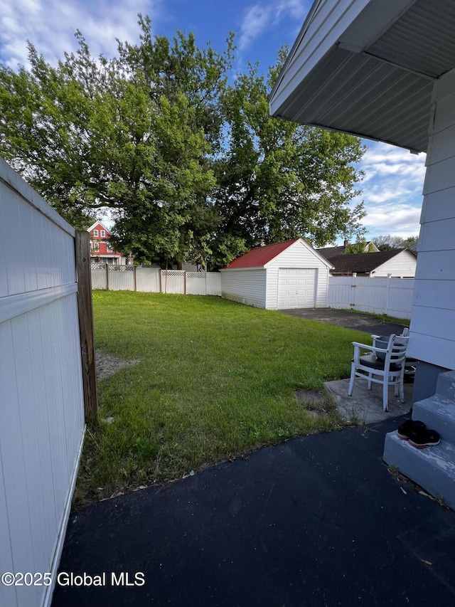 94 Willow Ave, Schenectady, NY 12304 - view of yard with a garage, a patio area, and asphalt driveway