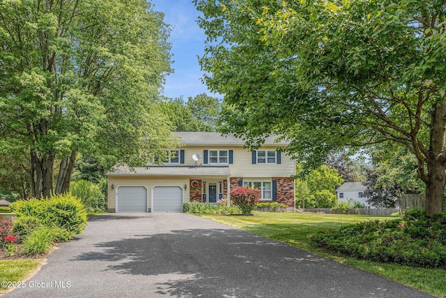 228 Vincenza Ln, Guilderland, NY 12303 - view of front facade with asphalt driveway, an attached garage, and brick siding