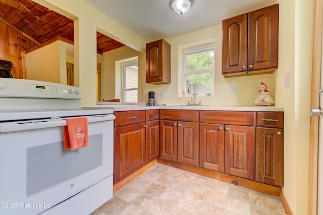 165 Lake Rd, Westerlo, NY 12023 - kitchen featuring electric range, a sink, light countertops, and brown cabinets