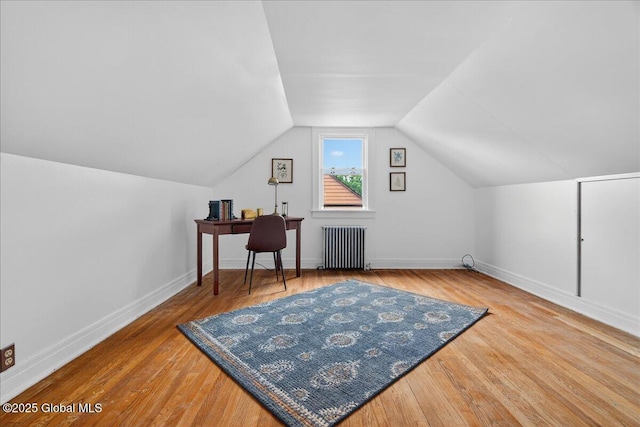14 Grounds Pl, Colonie, NY 12205 - additional living space with radiator heating unit, wood finished floors, lofted ceiling, and a desk