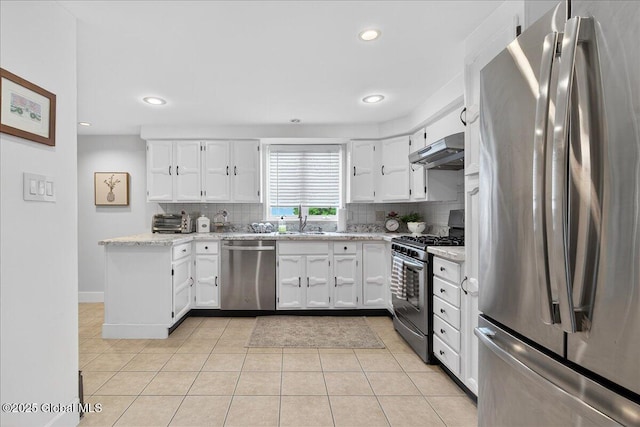 14 Grounds Pl, Colonie, NY 12205 - kitchen with stainless steel appliances, under cabinet range hood, backsplash, white cabinetry, and recessed lighting