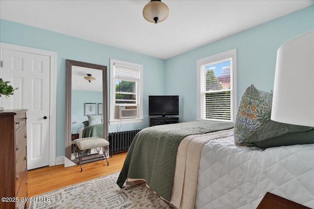 14 Grounds Pl, Colonie, NY 12205 - bedroom with radiator, light wood-style flooring, and cooling unit