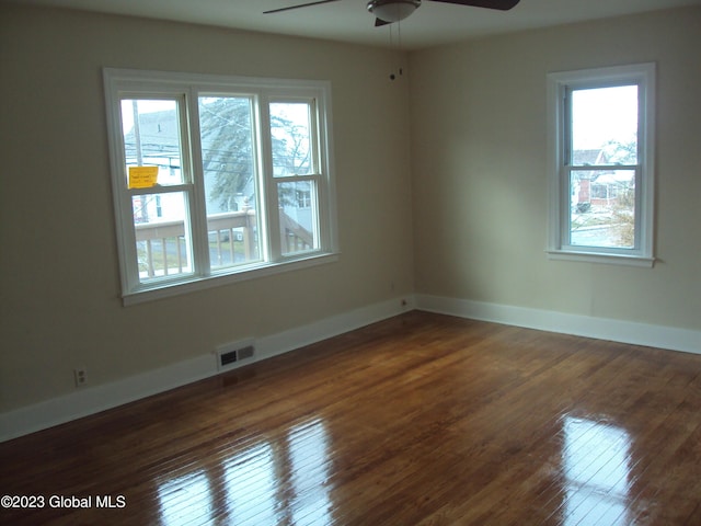 254 Church St, Amsterdam, NY 12010 - spare room with plenty of natural light, a ceiling fan, wood-type flooring, and baseboards