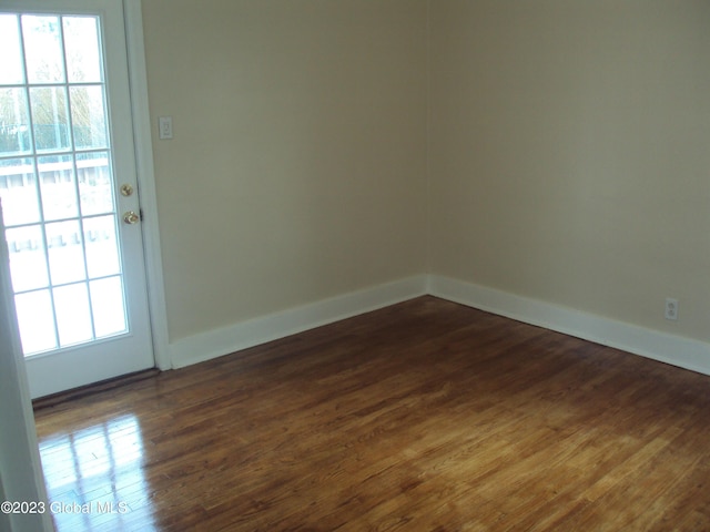 254 Church St, Amsterdam, NY 12010 - spare room featuring plenty of natural light, dark wood finished floors, and baseboards