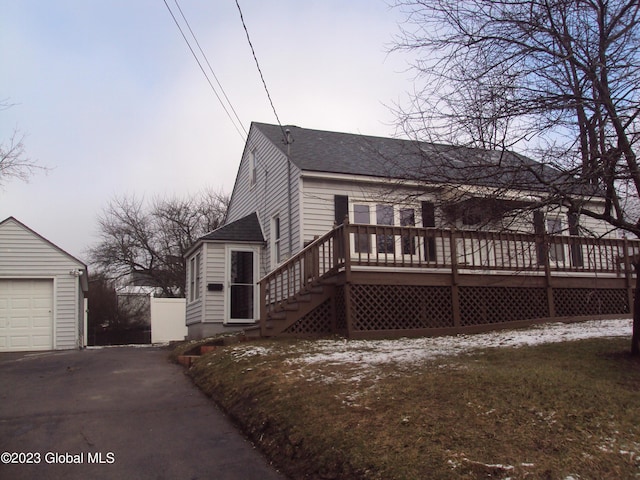 254 Church St, Amsterdam, NY 12010 - view of front of house with a shingled roof, a deck, an outbuilding, and asphalt driveway