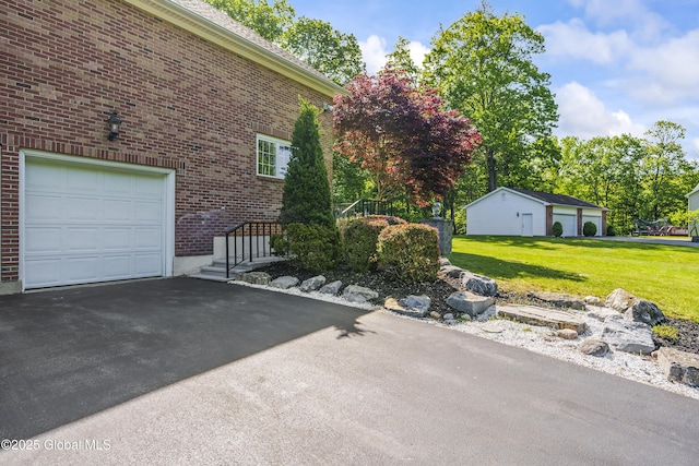 17 Brendan Ln, Niskayuna, NY 12309 - view of side of property with asphalt driveway, brick siding, and a lawn