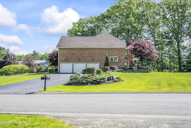 17 Brendan Ln, Niskayuna, NY 12309 - view of front of property featuring driveway, a garage, brick siding, a front yard, and a chimney