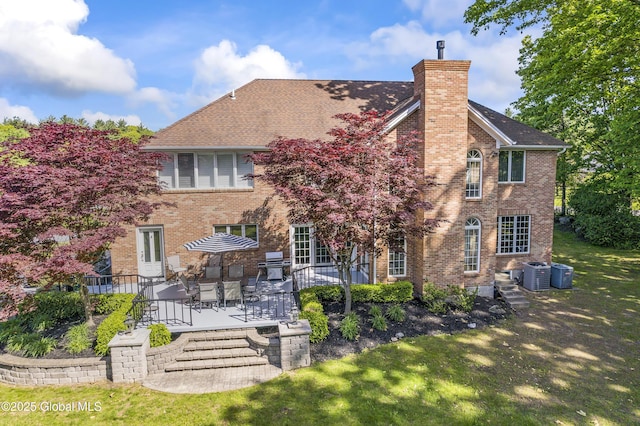 17 Brendan Ln, Niskayuna, NY 12309 - back of property featuring cooling unit, a chimney, a patio area, and brick siding