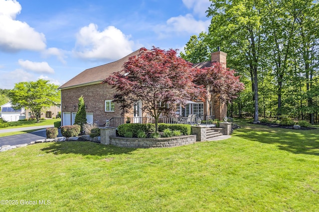 17 Brendan Ln, Niskayuna, NY 12309 - view of front of home with brick siding, a chimney, and a front lawn