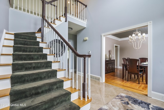 17 Brendan Ln, Niskayuna, NY 12309 - stairs featuring baseboards, a chandelier, a towering ceiling, and crown molding