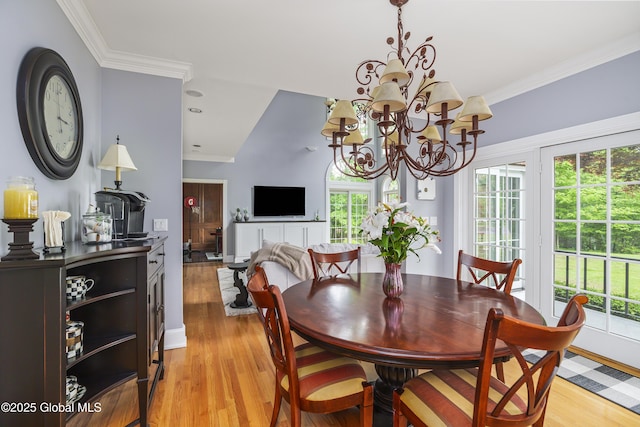 17 Brendan Ln, Niskayuna, NY 12309 - dining room featuring a chandelier, light wood-style flooring, healthy amount of natural light, ornamental molding, and baseboards