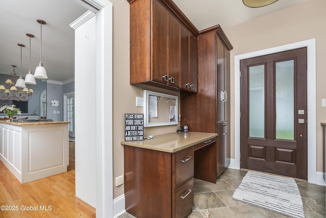 17 Brendan Ln, Niskayuna, NY 12309 - kitchen featuring light countertops, baseboards, hanging light fixtures, ornamental molding, and a chandelier