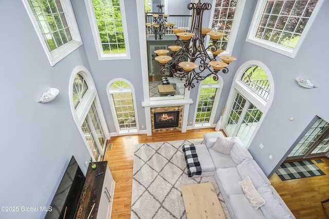 17 Brendan Ln, Niskayuna, NY 12309 - living area with a high ceiling, a chandelier, wood finished floors, and healthy amount of natural light