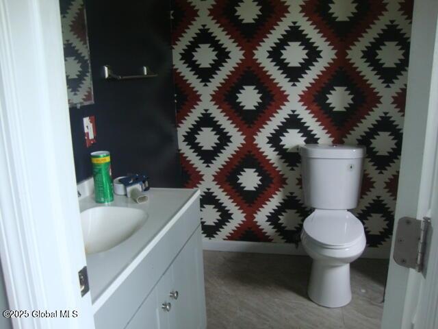422 W Ames Rd, Canajoharie, NY 13317 - bathroom with vanity, toilet, and baseboards
