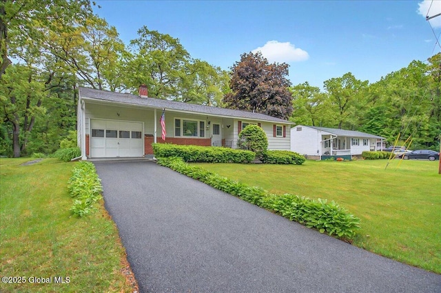 3 N Jordan Dr, Saratoga Springs, NY 12866 - ranch-style house with a garage, a chimney, brick siding, driveway, and a front lawn