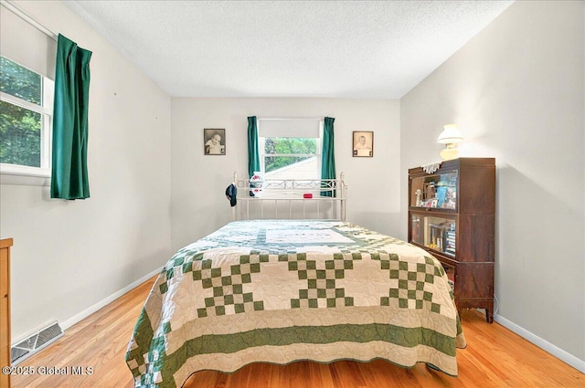 3 N Jordan Dr, Saratoga Springs, NY 12866 - bedroom with light wood-style flooring and a textured ceiling