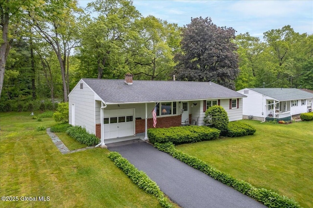 3 N Jordan Dr, Saratoga Springs, NY 12866 - single story home with an attached garage, brick siding, a chimney, and a front yard