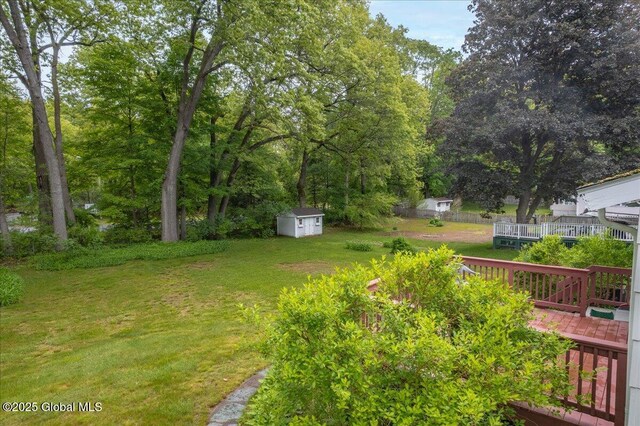 3 N Jordan Dr, Saratoga Springs, NY 12866 - view of green lawn with a storage shed and a wooden deck