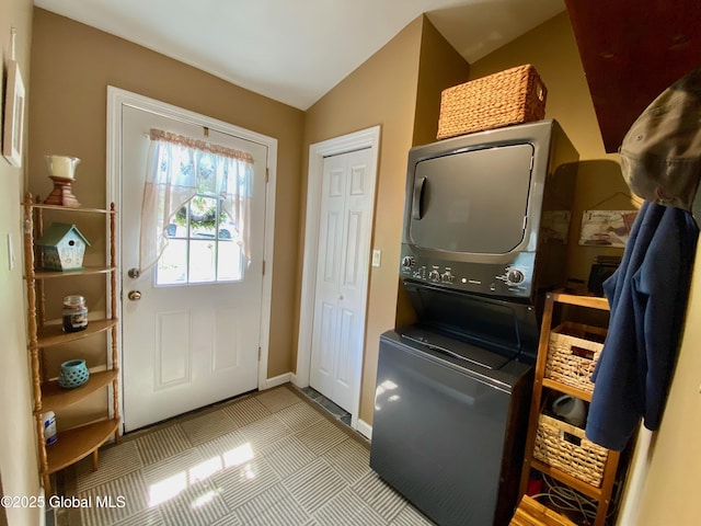 1926 Golf Ave, Schenectady, NY 12308 - laundry area featuring stacked washing machine and dryer, baseboards, and tile patterned floors