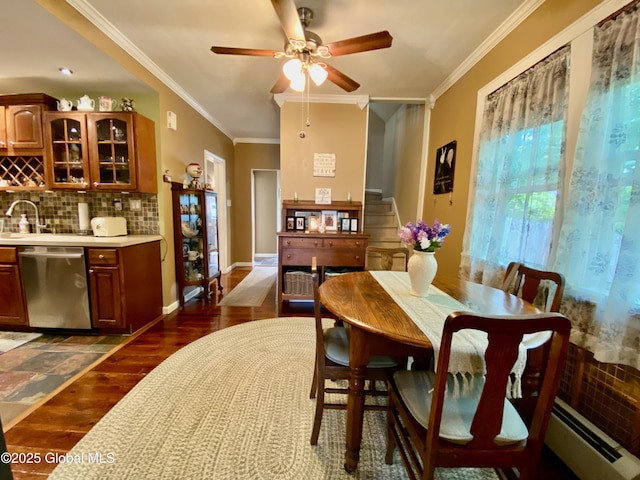 1926 Golf Ave, Schenectady, NY 12308 - dining room featuring baseboard heating, dark wood finished floors, crown molding, ceiling fan, and baseboards