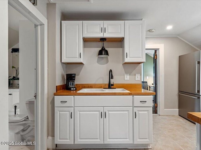 2 Van Rensselear St, Saratoga Springs, Inside, NY 12866 - kitchen featuring freestanding refrigerator, a sink, white cabinetry, baseboards, and wood counters