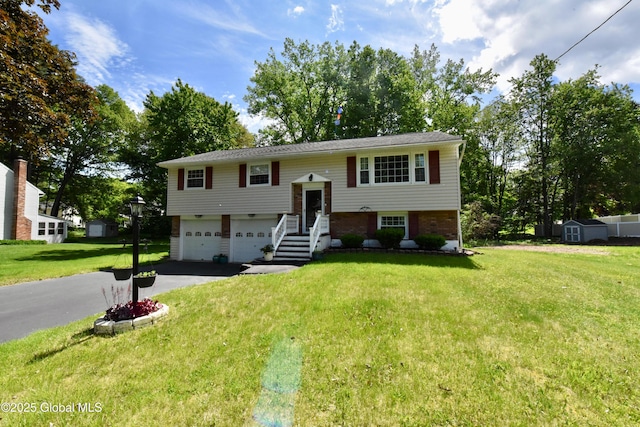 23 Bayberry Dr, Halfmoon, NY 12065 - bi-level home with asphalt driveway, an attached garage, brick siding, a front lawn, and a storage shed