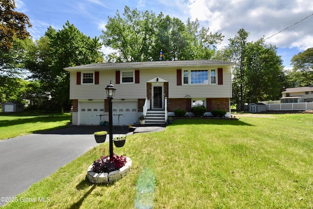 23 Bayberry Dr, Halfmoon, NY 12065 - raised ranch featuring driveway, an attached garage, brick siding, a front lawn, and a storage unit