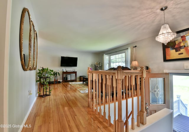 23 Bayberry Dr, Halfmoon, NY 12065 - corridor featuring a chandelier, light wood-type flooring, and baseboards