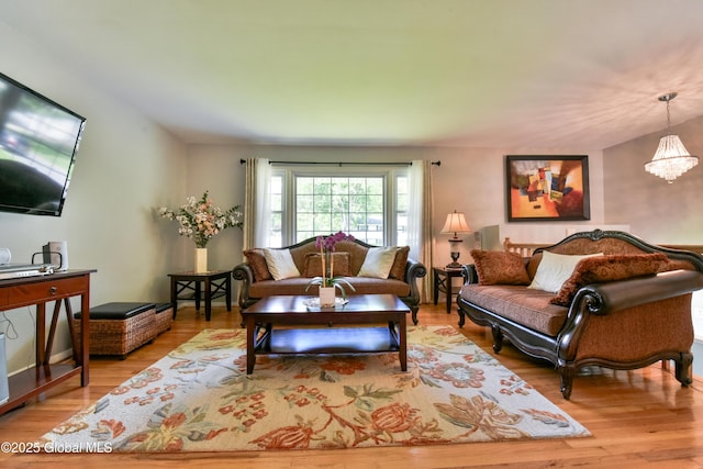 23 Bayberry Dr, Halfmoon, NY 12065 - living area with light wood-type flooring and a chandelier