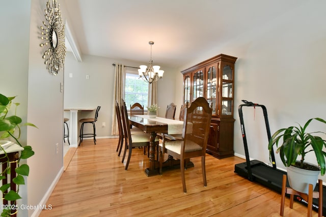 23 Bayberry Dr, Halfmoon, NY 12065 - dining area with a chandelier, light wood-style flooring, and baseboards