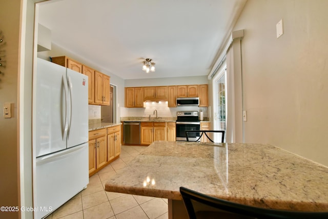 23 Bayberry Dr, Halfmoon, NY 12065 - kitchen featuring stainless steel appliances, light tile patterned floors, light stone counters, decorative backsplash, and a sink