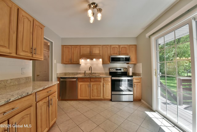 23 Bayberry Dr, Halfmoon, NY 12065 - kitchen featuring appliances with stainless steel finishes, a sink, backsplash, light stone counters, and light tile patterned flooring