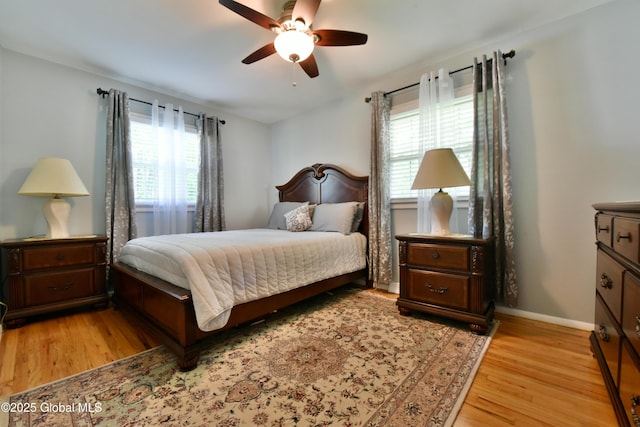 23 Bayberry Dr, Halfmoon, NY 12065 - bedroom with light wood-style floors, multiple windows, a ceiling fan, and baseboards
