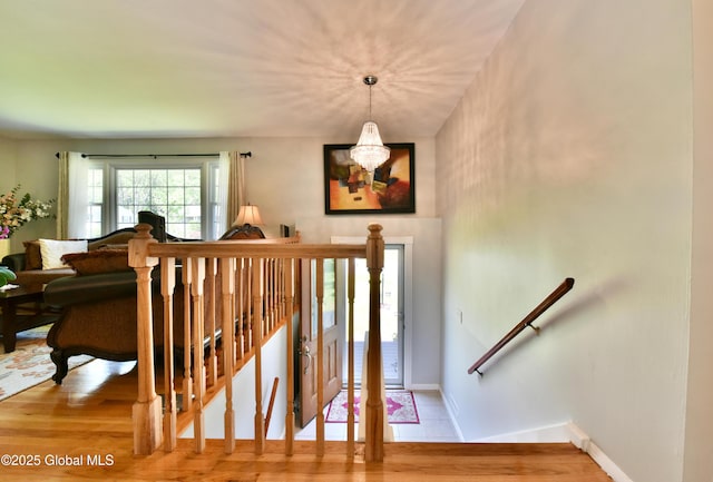 23 Bayberry Dr, Halfmoon, NY 12065 - stairs with a chandelier, baseboards, and wood finished floors