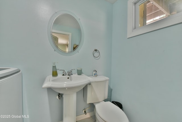 23 Bayberry Dr, Halfmoon, NY 12065 - bathroom with washer / dryer, toilet, baseboards, and a sink