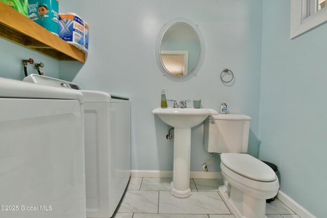 23 Bayberry Dr, Halfmoon, NY 12065 - bathroom with independent washer and dryer, toilet, baseboards, marble look tiles, and a sink