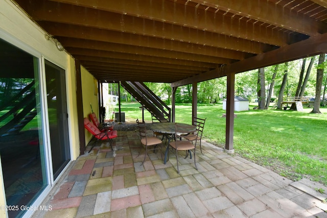 23 Bayberry Dr, Halfmoon, NY 12065 - view of patio with outdoor dining area, stairs, and an outbuilding