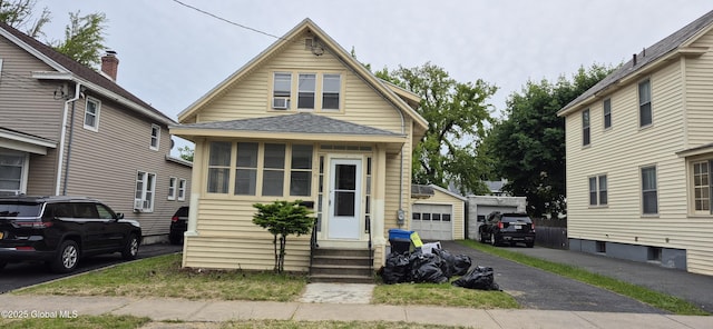 176 Benson St, Albany, NY 12206 - view of front facade with entry steps, an outdoor structure, a shingled roof, and a garage