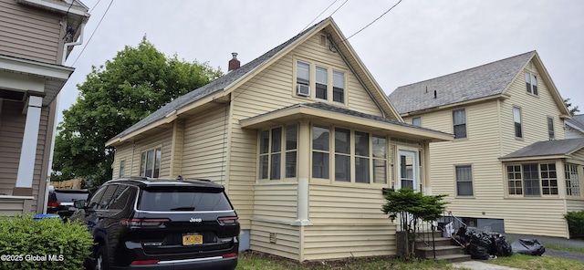 176 Benson St, Albany, NY 12206 - view of side of home featuring a chimney and entry steps