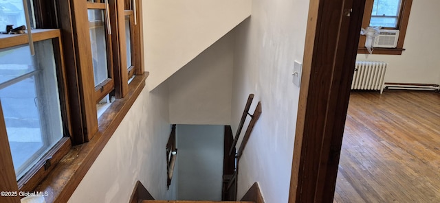 176 Benson St, Albany, NY 12206 - stairway with radiator, cooling unit, and wood finished floors