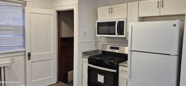 176 Benson St, Albany, NY 12206 - kitchen featuring freestanding refrigerator, stainless steel range with gas stovetop, and white cabinetry