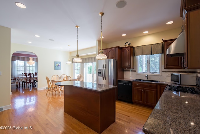 1 Avalon Ct, Colonie, NY 12211 - kitchen featuring appliances with stainless steel finishes, wall chimney exhaust hood, arched walkways, plenty of natural light, and recessed lighting
