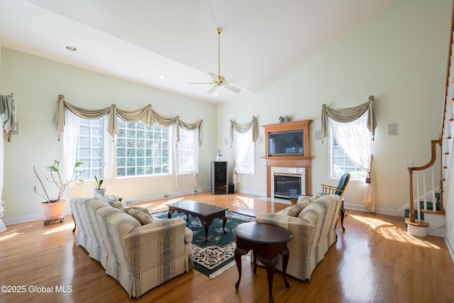 1 Avalon Ct, Colonie, NY 12211 - living room with stairway, a fireplace with flush hearth, wood finished floors, ceiling fan, and baseboards